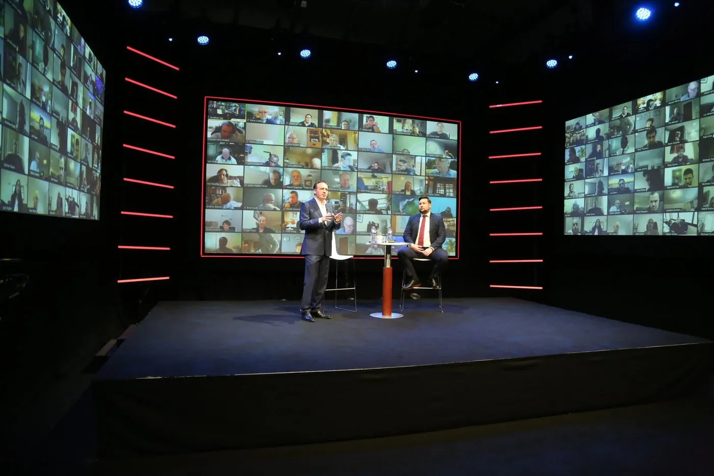 Interview set on the IGNITE Studios stage, with remote attendees on the LED walls